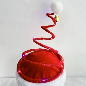 Close-up of a red spiral Christmas hat with LED lights, golden bell, and white pom-pom detail