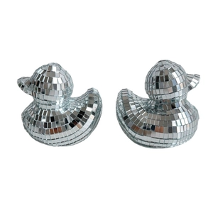 Macro view of mirror glass tiles on two silver disco ball duck figurines for home decor