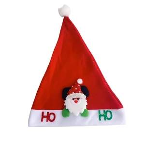 Detail view of festive red Christmas hat with HO HO embroidery and 3D Santa cartoon patch