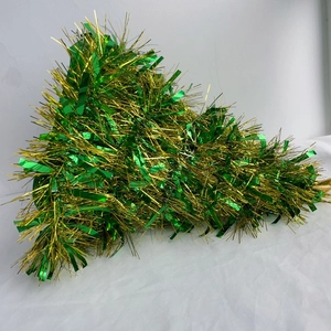 Close-up of sparkling green and gold tinsel garland for festive Christmas decoration