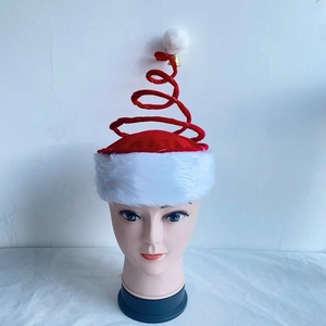 Macro shot of a red spring spiral Christmas hat with small bell and white pom pom detail