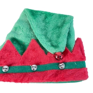 Detailed view of red and green plush Christmas elf hat with silver bells for festive parties