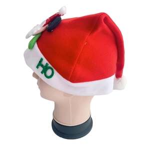 Detail of red Christmas hat featuring white plush trim and sparkling green HO sequins