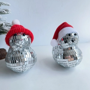 Close-up of disco ball mirrored ducks wearing festive red Santa hats for Christmas decor