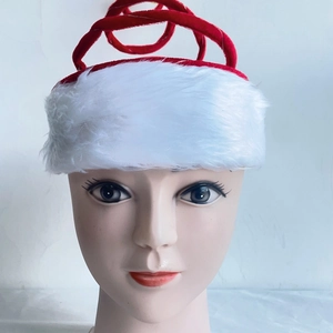 Close-up of red velvet and white plush Christmas spring hat on a display head
