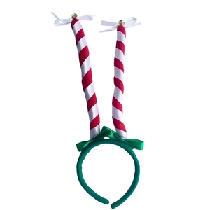Detail of Christmas headband with red white striped poles and golden bells on top