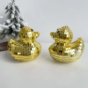 Detailed close-up of golden disco mirror duck figurines with reflective glass tiles