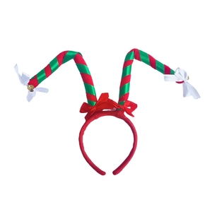 Macro detail of Christmas headband with red green striped antlers and gold bells