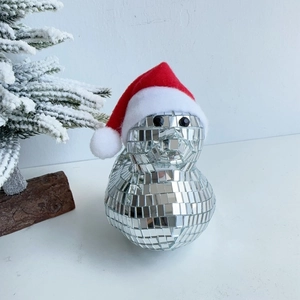 Close-up of sparkling disco mirror duck with festive red and white Christmas hat decor