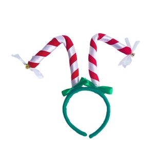 Detailed view of Christmas headband with red and white candy canes and green velvet finish