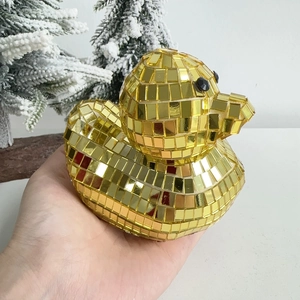Close-up of golden disco mirror duck figurine with shimmering mosaic glass tiles