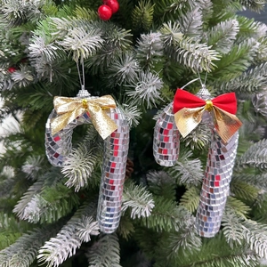 Disco mirror candy cane ornaments with glitter bows hanging on a Christmas tree