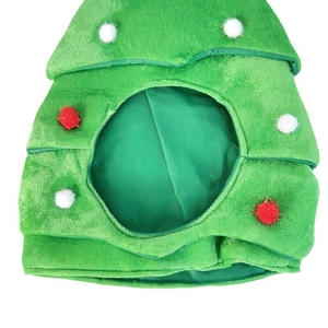 Detail of green Christmas tree hat for pets made of soft plush with colorful pompoms