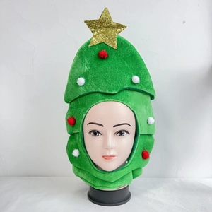 Detail of Christmas tree party hat with gold star and festive red and white pom-poms