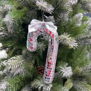 Close-up of disco mirror ball candy cane ornament with silver bow on Christmas tree