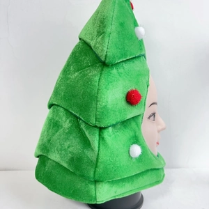 Detail showing a plush Christmas tree hat with colorful pom-poms on a white background