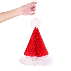 Detail of hanging honeycomb paper Christmas hat ornament with a white pom-pom and loop