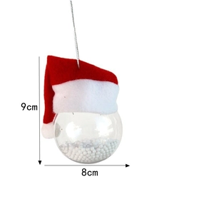 Detailed view of 9x8cm clear Christmas ball ornament with red Santa hat and snow filling