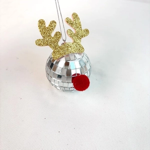 Détail d'une boule disco renne avec bois dorés et nez en pompon rouge