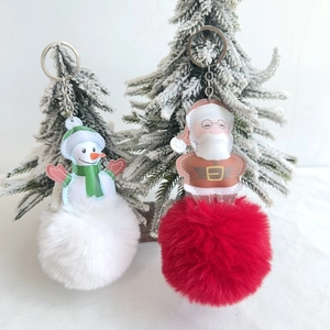 Christmas snowman and Santa Claus keychains with large faux fur pompoms on silver ring