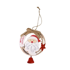 Detail of wooden Christmas ornament with Santa Claus, burlap bow and red metal bell