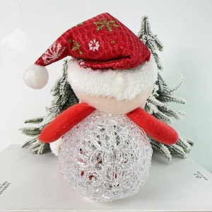 Close-up of a festive LED Santa doll with a red snowflake hat and glowing acrylic body