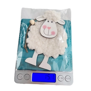 Detailed view of an Easter felt sheep ornament weighing 15.1g on a digital scale