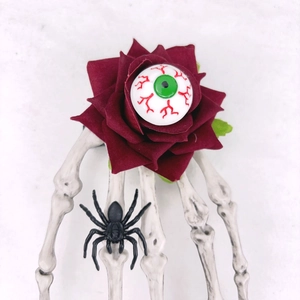 Barrette d'Halloween avec rose rouge, œil réaliste et détail de main de squelette