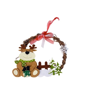 Detail of Christmas rattan wreath with felt reindeer and snowy tree on white background
