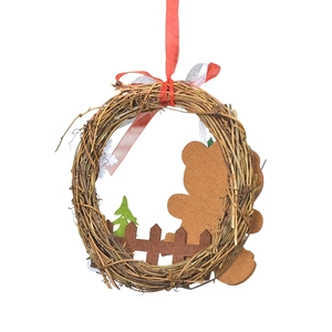 Christmas rattan wreath decoration with brown felt bear, wooden fence and green pine tree