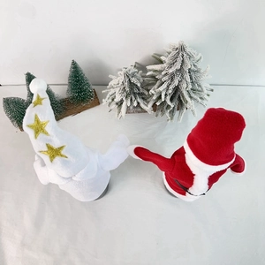 Detail view of plush Christmas wine bottle covers with Santa and star patterns