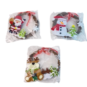 Close-up of rustic Christmas rattan wreaths with Santa, Snowman and Reindeer figurines