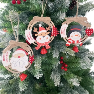 Close-up of wooden Christmas tree ornaments with Santa, reindeer and snowman figures