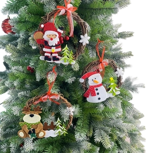 Close-up of Santa, snowman, and elk felt figures on natural rattan wreaths ornaments