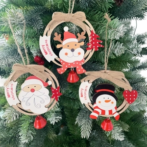 Close-up of wooden Christmas ornaments with Santa, snowman, and reindeer on a tree