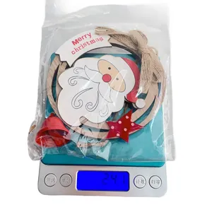 Weight measurement of a wooden Christmas ornament with Santa and bells in packaging