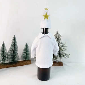 Detailed view of white fleece Christmas wine bottle cover with gold star embroidery