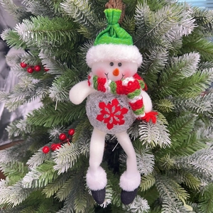 Detailed view of a plush snowman Christmas ornament with silver LED ball and snowflake