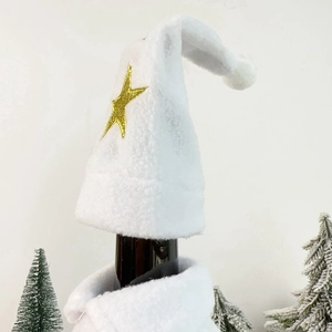 Close-up of white plush Christmas wine bottle cover with gold embroidered star detail