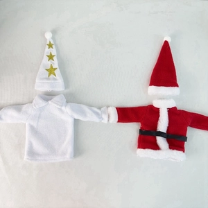 Detail of red and white Christmas wine bottle covers with cute tiny hats and belts