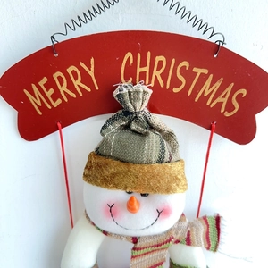 Detail der flauschigen Weihnachts-Schneemann-Dekoration mit Merry Christmas-Schild