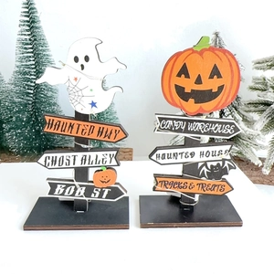 Detail view of Halloween wooden table signs with LED lights and festive pumpkin ghost motifs