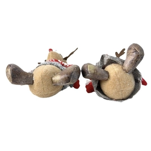 Detail view of the bottom craftsmanship and fabric texture on plush Christmas reindeer dolls