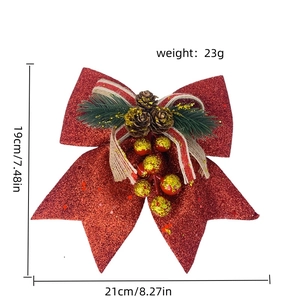 Detailed view of red sequin Christmas bow with pine cones and festive berries