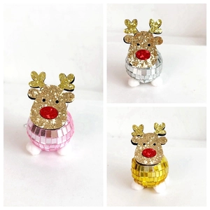 Close-up of glitter reindeer disco balls in pink, silver and gold festive colors