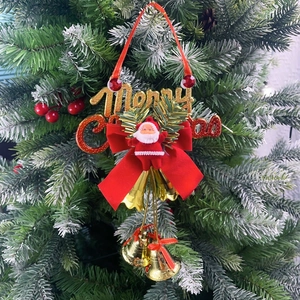 Detail of Christmas tree ornament with Santa, gold bells and red velvet bow