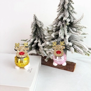 Close-up of pink and gold disco ball reindeer ornaments for festive Christmas tree decor