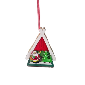 Close-up of wooden Christmas house ornament with Santa Claus and green pine trees
