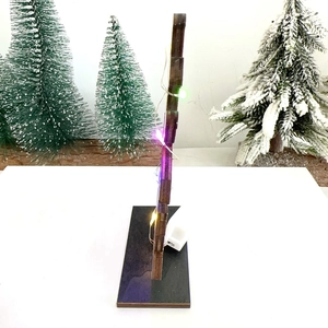Side view of wooden Halloween pumpkin ornament with colorful LED lights and battery box
