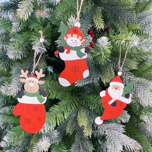 Detailed view of wood Christmas tree ornaments featuring Santa, Snowman and Reindeer motifs